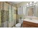 Bathroom featuring a colorful shower curtain, wooden vanity, and mirror at 1300 Shady Pine Way # B, Tarpon Springs, FL 34688