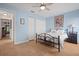 Bright bedroom with light blue walls, hardwood floors, and natural light at 1300 Shady Pine Way # B, Tarpon Springs, FL 34688