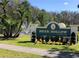 Welcome to Deer Hollow at East Lake: a community sign with a water fountain in the background at 1300 Shady Pine Way # B, Tarpon Springs, FL 34688