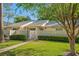 Charming condo with a well-manicured lawn, inviting walkway, and decorative fence at 1300 Shady Pine Way # B, Tarpon Springs, FL 34688