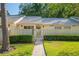 Charming condo with a well-manicured lawn, inviting walkway, and decorative fence at 1300 Shady Pine Way # B, Tarpon Springs, FL 34688
