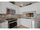 Modern kitchen featuring granite countertops and stainless steel appliances at 1300 Shady Pine Way # B, Tarpon Springs, FL 34688