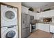Well-equipped kitchen with stainless steel appliances, including a stacked washer/dryer at 1300 Shady Pine Way # B, Tarpon Springs, FL 34688