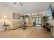 Comfortable living room with sliding glass doors, tile floors, and cozy seating area at 1300 Shady Pine Way # B, Tarpon Springs, FL 34688
