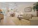 Bright living room with tile floors, neutral walls, and comfortable seating, creating an inviting and airy atmosphere at 1300 Shady Pine Way # B, Tarpon Springs, FL 34688
