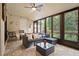Cozy sunroom with a comfortable sectional, decorative tile flooring, and access to the outdoors at 1300 Shady Pine Way # B, Tarpon Springs, FL 34688