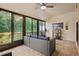 Relaxing sunroom featuring tile floors, fan, and furniture overlooking lush greenery at 1300 Shady Pine Way # B, Tarpon Springs, FL 34688