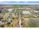 Expansive aerial view showcases the property's location within a well-planned community, near a tranquil lake at 13411 Graham Yarden Dr, Riverview, FL 33579