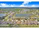 Aerial view of a charming home in a well-planned community with lakes, lush greenery, and open spaces at 13411 Graham Yarden Dr, Riverview, FL 33579