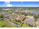 Beautiful neighborhood aerial view of this home, showcasing its prime location near a lake and lush landscaping at 13411 Graham Yarden Dr, Riverview, FL 33579