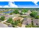 Neighborhood aerial view showcasing this home's proximity to a scenic lake, landscaping, and nearby amenities at 13411 Graham Yarden Dr, Riverview, FL 33579
