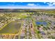 A vast aerial shot displays a residential area dotted with serene lakes and lush greenery, highlighting community charm at 13411 Graham Yarden Dr, Riverview, FL 33579