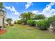 This spacious backyard features lush green grass, well-maintained landscaping, and privacy fencing at 13411 Graham Yarden Dr, Riverview, FL 33579