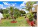 Expansive backyard with green grass, bordered by landscaping, shrubs, and mulch, perfect for outdoor activities at 13411 Graham Yarden Dr, Riverview, FL 33579