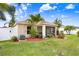 View of a well-maintained backyard, featuring a screened in lanai and lush landscaping, surrounded by a fence at 13411 Graham Yarden Dr, Riverview, FL 33579