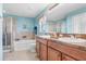 Large bathroom with double sink vanity, tile floors, shower and soaking tub at 13411 Graham Yarden Dr, Riverview, FL 33579