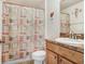 Charming bathroom with decorative shower curtain, vanity with sink, and coordinated accessories at 13411 Graham Yarden Dr, Riverview, FL 33579