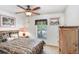 Bright bedroom featuring a ceiling fan, soft carpet, neutral walls, and cheerful decor at 13411 Graham Yarden Dr, Riverview, FL 33579
