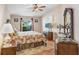 Warm bedroom with vaulted ceiling, wood floors, ceiling fan and warm neutral walls at 13411 Graham Yarden Dr, Riverview, FL 33579