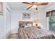 Charming bedroom with a ceiling fan, cozy bed, and a serene setting for comfortable living at 13411 Graham Yarden Dr, Riverview, FL 33579