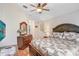 Warm bedroom with wood floors, ceiling fan, warm neutral walls and bright light at 13411 Graham Yarden Dr, Riverview, FL 33579