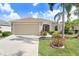 Well-maintained single-story home with an attached garage, manicured lawn, and neatly arranged landscaping at 13411 Graham Yarden Dr, Riverview, FL 33579