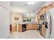 Open-concept kitchen with stainless steel appliances, granite countertops, and a breakfast bar overlooking the dining area at 13411 Graham Yarden Dr, Riverview, FL 33579