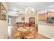 Open-concept living space with a dining area, tile backsplash, and seamless flow to the adjacent room at 13411 Graham Yarden Dr, Riverview, FL 33579