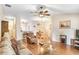 Open living space featuring hardwood floors, comfortable seating, and a dining area with stylish decor at 13411 Graham Yarden Dr, Riverview, FL 33579