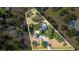 Aerial view featuring the property and neighborhood, emphasizing the pool and surrounding mature trees at 1350 Mustang St, Nokomis, FL 34275