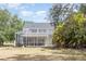 Spacious backyard with screened-in pool, patio, and lush landscaping offering outdoor privacy at 1350 Mustang St, Nokomis, FL 34275