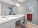This bathroom has a sink, mirror, vanity, and multiple windows, providing ample natural lighting at 1350 Mustang St, Nokomis, FL 34275