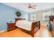 Comfortable bedroom featuring a bed, windows, and ceiling fan at 1350 Mustang St, Nokomis, FL 34275