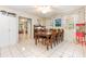 Inviting dining room featuring a wood dining table, large windows, and tile flooring at 1350 Mustang St, Nokomis, FL 34275