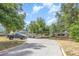 Wide driveway leading up to a charming home with a welcoming front porch at 1350 Mustang St, Nokomis, FL 34275