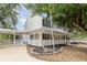 An exterior side view of a charming two-story home featuring a spacious porch at 1350 Mustang St, Nokomis, FL 34275