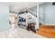 Inviting foyer with tile floors, staircase, and storage system at 1350 Mustang St, Nokomis, FL 34275