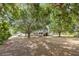 Home with mature trees, a welcoming front porch, and a spacious manicured front yard at 1350 Mustang St, Nokomis, FL 34275