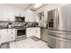 Modern kitchen with stainless steel appliances, granite countertops, and ample storage space at 1350 Mustang St, Nokomis, FL 34275