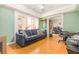 Cozy living room with wood floors, comfortable seating, and natural light at 1350 Mustang St, Nokomis, FL 34275