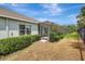 View of the backyard with a screen enclosed porch, landscaping and privacy fence at 13518 Circa Crossing Dr, Lithia, FL 33547