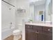 Bright bathroom featuring dark cabinets, shower, tub, and modern fixtures at 13518 Circa Crossing Dr, Lithia, FL 33547