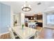 Dining area showing open floor plan to kitchen with an island and breakfast bar at 13518 Circa Crossing Dr, Lithia, FL 33547
