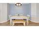 Bright dining area with light blue walls, dining table and chairs under modern chandelier at 13518 Circa Crossing Dr, Lithia, FL 33547