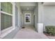 Inviting entryway with blue accents, bright lighting, and a tidy front porch at 13518 Circa Crossing Dr, Lithia, FL 33547