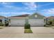 Beautiful home featuring dual garages, green landscaping, and a serene, cloud-filled sky at 13518 Circa Crossing Dr, Lithia, FL 33547