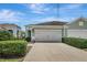Charming home showcasing a well-manicured lawn, lush greenery, and a two-car garage at 13518 Circa Crossing Dr, Lithia, FL 33547