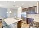 Bright kitchen featuring stainless steel appliances, a central island, and pendant lighting at 13518 Circa Crossing Dr, Lithia, FL 33547