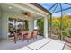 The screened lanai offers a ceiling fan, dining table with seating, and bright natural light for enjoying the outdoors at 13518 Circa Crossing Dr, Lithia, FL 33547