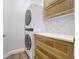 Updated laundry room with stacked washer/dryer and custom cabinets at 13518 Circa Crossing Dr, Lithia, FL 33547